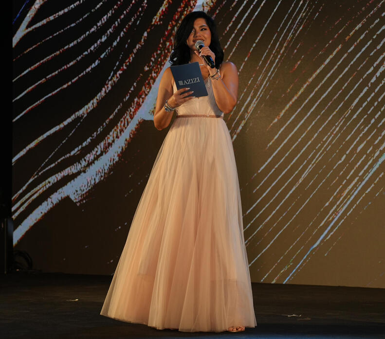 alt="MC Dija hosting Azizi Developments event in Dubai" alt="Bilingual emcee on stage for Huawei corporate event"